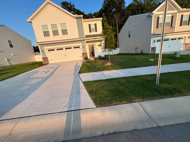 Front yard with a trimmed lawn edged along the walkway and driveway